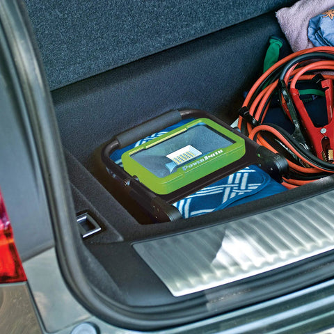 Beefy 2400 Lumen LED Work Light With Foldable Magnetic Base USB Charging Port in car trunk next to jumper cables