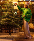 Person decorating Christmas tree with Battery Operated Fairy Lights 10Ft 120 LED Firecracker String Lights With 6 Hour Timer Waterproof Silver Wire.