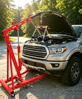 No Sweat 4400 Pound Engine Hoist Cherry Picker with adjustable boom lifting engine over a truck hood outdoors.