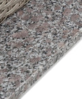 Close-up of granite base and wicker detail of Outdoor Must Have Transitional Metal And All Weather Wicker Square Patio Table