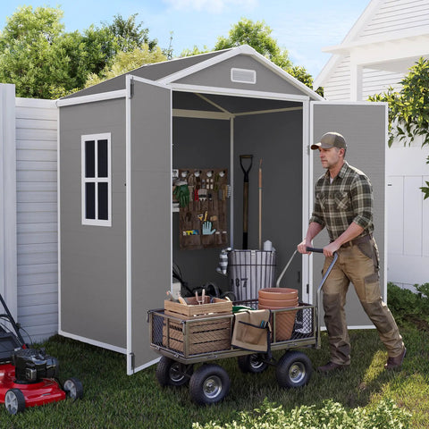 Man organizing tools inside a Spacious 6x4 Outdoor Storage Shed With Floor For Bikes Tools And Gear in gray and white.
