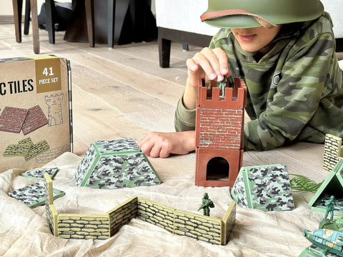Child playing with Military Battlefield Base Magnetic Tiles Building Blocks Army War Themed Playset for imaginative STEM learning.
