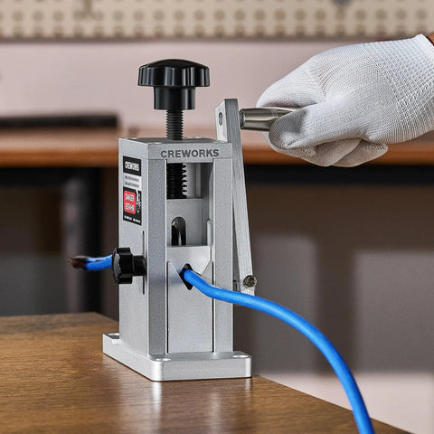 Drill Powered Wire Stripper Machine With Adjustable Feed Hole For Scrap Copper Wire 0.06 To 0.09 Inch in use with hand crank.