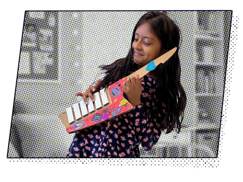 Keytar Invention Launchpad Starter Bundle For Hands On STEM Coding Learning Build Your Own Musical Instrument Kit That Lets Kids Create Code Play And Customize An Educational Instrument. girl holding cardboard keytar with keys