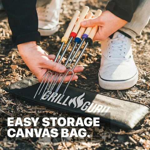 Person handling 32 Inch Smores Skewers 5 Pack For Campfire Marshmallow Roasting Stainless Steel Roasting Forks with canvas bag.