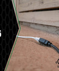 Heavy Duty 12/3 25 Foot Extension Cord For Farm And Shop Use All Copper Wire SJTOW Weather Rated laying on dirt surface.