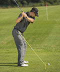 Golfer using Two 48 Inch Golf Alignment Sticks Swing Trainer Yellow Set Of 2 With Portable Storage Tube on the range