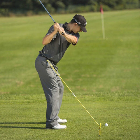 Golfer using Two 48 Inch Golf Alignment Sticks Swing Trainer Yellow Set Of 2 With Portable Storage Tube on the range