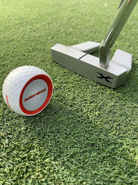 Golf Putting Training Aid With Instant Feedback For Stroke Improvement On Practice Green Or Mat Realistic Ball Feels And Weighs Like A Real Golf Ball Detects Mis Hits And Boosts Accuracy And Confidence next to putter on grass