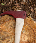 Hookaroon Log Grabber Tool, 1.5 Lb, 36 Inch Curved Wooden Handle With Forged Steelhead resting on tree stump outdoors.
