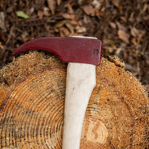 Hookaroon Log Grabber Tool, 1.5 Lb, 36 Inch Curved Wooden Handle With Forged Steelhead resting on tree stump outdoors.