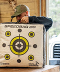 Person holding Pro Grade 20 Inch Archery Field Point Target For All Bow Types With High Density Material Dual Sided Aiming Points