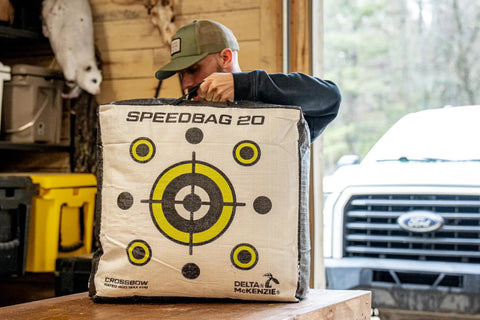 Person holding Pro Grade 20 Inch Archery Field Point Target For All Bow Types With High Density Material Dual Sided Aiming Points
