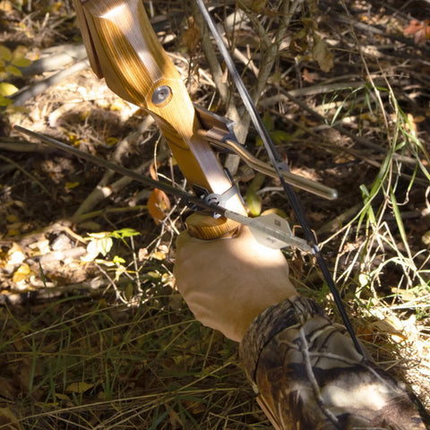 Traditional Arrow Holder With Vented Retainer For Archery Gear mounted on recurve bow in forest setting