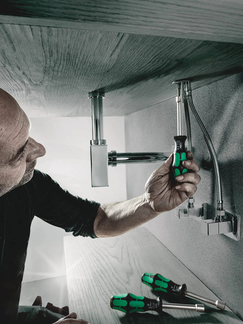 Man using 7 Millimeter Nut Driver With Hollow Shaft And Kraftform Plus Grip For Quick Torque Handy Tightening And Loosening 90 mm Length Nutspinner Tool For Pros under sink