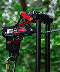 All In One Zip Line Trolley Pro X With Brake Bundle featuring heavy duty carabiner and lanyard on cable setup in a forest setting.