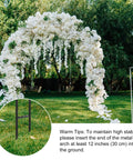 7.8Ft Garden Arch Trellis Black Metal Frame For Climbing Plants Ideal For Weddings Parties And Garden Entrances Durable Outdoor Archway enhanced with white flowers