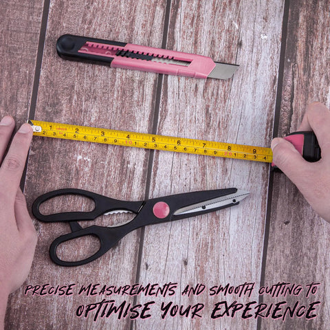 39 Piece Pink Household Tool Set With Storage Case For Home DIY Projects Includes Hammer Pliers Screwdrivers Tape Measure And More Durable Chrome Plated Tools For Quick Fixes And Everyday Repairs image showing tape measure, scissors, and utility knife on wooden surface.