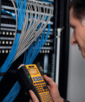 Technician using Rhino 5200 Label Maker With One Touch Hot Keys For Speedy, Durable Asset Labeling On Job Sites