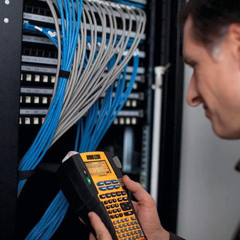 Technician using Rhino 5200 Label Maker With One Touch Hot Keys For Speedy, Durable Asset Labeling On Job Sites
