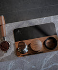 54mm Espresso Tamping Mat And Pro Grade Desk Ready Tool Organizer For Breville Espresso Machines Walnut Wood And Leather Tamp Station with tools displayed on a marble counter.