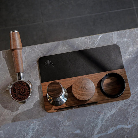 54mm Espresso Tamping Mat And Pro Grade Desk Ready Tool Organizer For Breville Espresso Machines Walnut Wood And Leather Tamp Station with tools displayed on a marble counter.