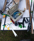 Beefy Post Hole Digger With No Slip H Grip Handles on a truck bed with other tools for yard work and gardening