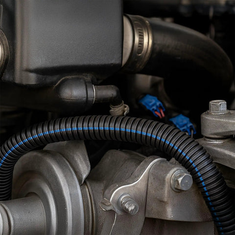 Close-up of 3/4 Inch Flame Retardant Polypropylene Split Wire Loom Tubing Corrugated Conduit with Flammability Tracer in engine setup