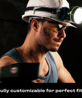 Man wearing Yellow Safety Glasses For Men, ANSI Z87 rated shooting eyewear with Scratch And Fog Resistant Lenses, holding a tool