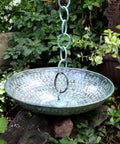 Large Sixteen And A Half Inch Diameter Rain Chain Basin In Blue Verde Pure Copper Hand Hammered Four Inch High Twenty Gauge Copper Connects Seamlessly To Rain Chains Dope Outdoor Decor in a garden setting.