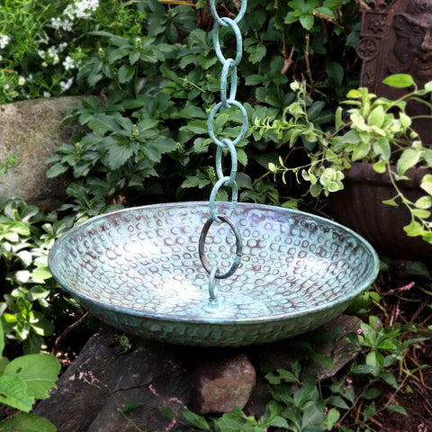 Large Sixteen And A Half Inch Diameter Rain Chain Basin In Blue Verde Pure Copper Hand Hammered Four Inch High Twenty Gauge Copper Connects Seamlessly To Rain Chains Dope Outdoor Decor in a garden setting.