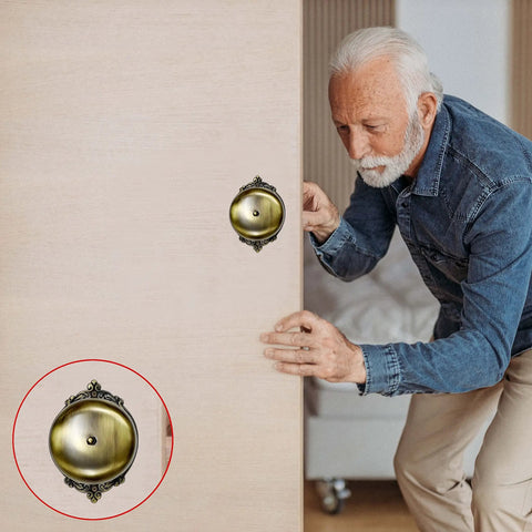 Vintage Victorian Twist Bell With Key Plate Mechanical Doorbell For Home Brass Calling Bell mounted on a door above an elderly man