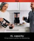 Couple using Programmable XL 14 Cup Barista Grade Coffee Maker Pro With Permanent Filter Classic Or Rich Brew Delay Brew Freshness Timer Keep Warm Dishwasher Safe Copper Finish.