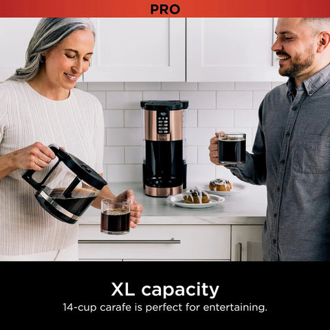 Couple using Programmable XL 14 Cup Barista Grade Coffee Maker Pro With Permanent Filter Classic Or Rich Brew Delay Brew Freshness Timer Keep Warm Dishwasher Safe Copper Finish.