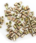 Top Shelf Carbon Steel Rivet Nuts M6 Thread Inserts Half Hex Nutsert Assortment Kit 60 Pieces Zinc Plated Yellow scattered on white background.
