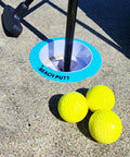 Beach Side Golf Set For The Sand With Two Adjustable Putters Waterproof Dry Bag Flags Cups Balls Sand Scoop And More For Family Fun On The Beach Game On This Summer showing yellow balls and a cup on sand.