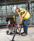 Worker using 16-Gallon Stainless Steel Wet Dry Shop Vacuum With Cart, Pro Hose, Drain And Blower Port, 6.5 Peak HP Motor, Red on site