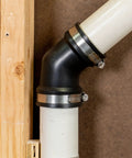 Qwik Ell 2 Inch Hub 45 Degree Flexible PVC DWV Elbow Fitting Connector for Drain Waste Vent Repair and Renovation installed on white pipe
