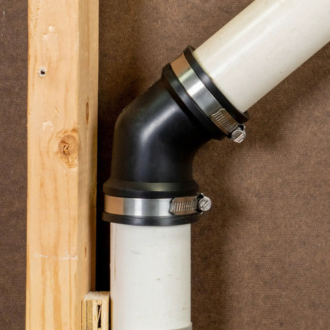 Qwik Ell 2 Inch Hub 45 Degree Flexible PVC DWV Elbow Fitting Connector for Drain Waste Vent Repair and Renovation installed on white pipe