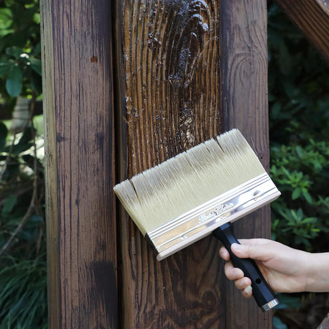 Person using 9 Inch Deck Stain Brush for Wood Wide 9 Inch Bristle Brush for Fast Even Stains and Sealants Smooth Finish on fence