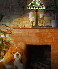 Irish Tiffany Style Table Lamp With Stained Glass Shade, Bronze Metal Base on brick mantel, warm ambient glow, 18 Inch Tall