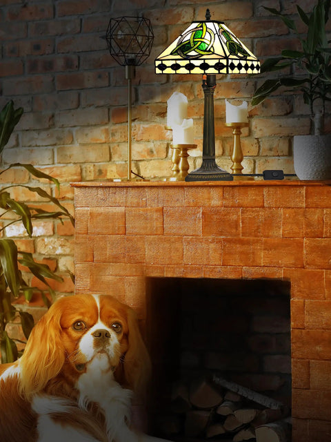 Irish Tiffany Style Table Lamp With Stained Glass Shade, Bronze Metal Base on brick mantel, warm ambient glow, 18 Inch Tall