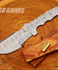 Damascus Tracker DIY Knife Kit With Knife Blank Steel Blade Pins Handle Scales And Leather Sheath On Wooden Surface