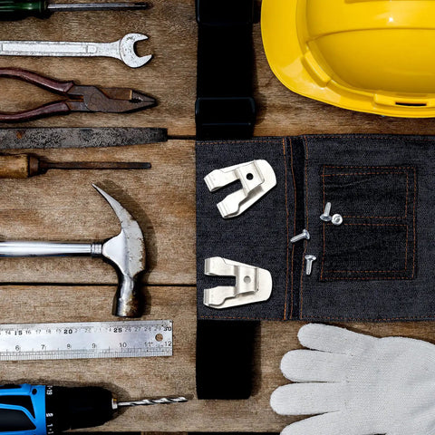 Stainless Steel Belt Clip Hooks For Drills with screws set on tool belt, surrounded by tools and safety gear, flat lay view