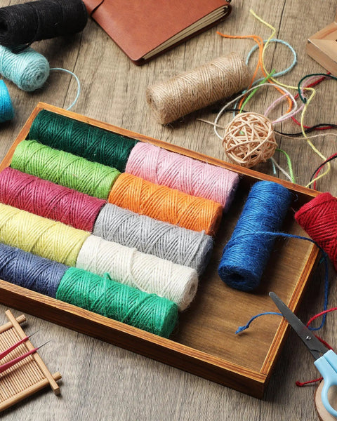 Colorful Jute Twine String Set, 2 Mm Thick, 16 Rolls visible in a wooden tray, ideal for crafts and DIY art projects.