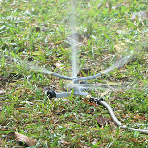 Heavy Duty Metal 3-Arm Rotating Sprinkler With Wheeled Base on grass, 360 Degree Lawn Sprinkler For Small Yards in action
