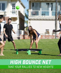 People playing with the Slammo XL Extra Large Round Net Game For Beginners on grass, visible net and ball, outdoors