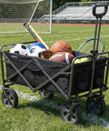 Collapsible Folding Outdoor Utility Wagon With Large Capacity And Easy Setup, heavy duty foldable wagon filled with sports gear, black.