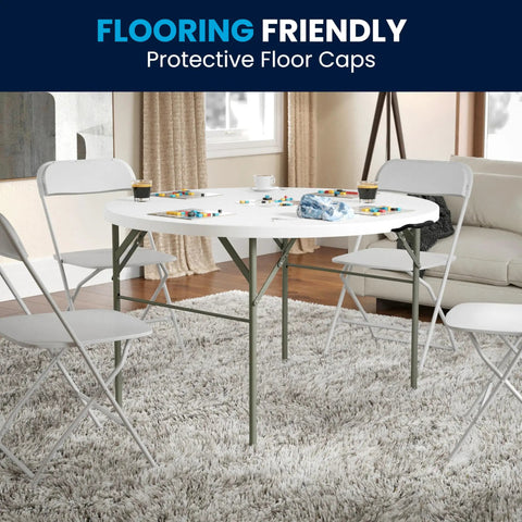 Grab And Go Ready 4 Foot Round Folding Plastic Table With Carrying Handle in living room setting with white chairs
