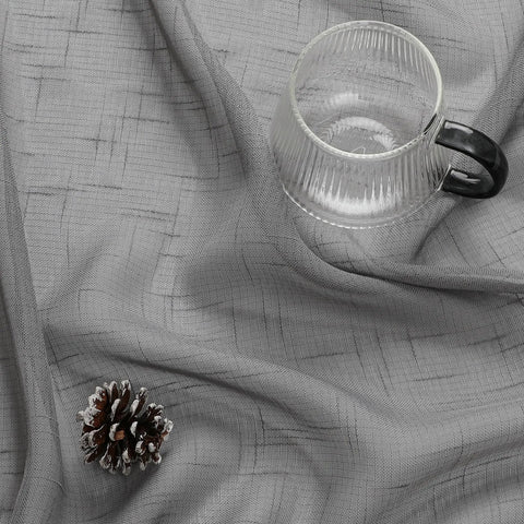 Gray Faux Linen Sheer Curtains Set, fabric detail with textured design, pine cone and glass mug placed on top.